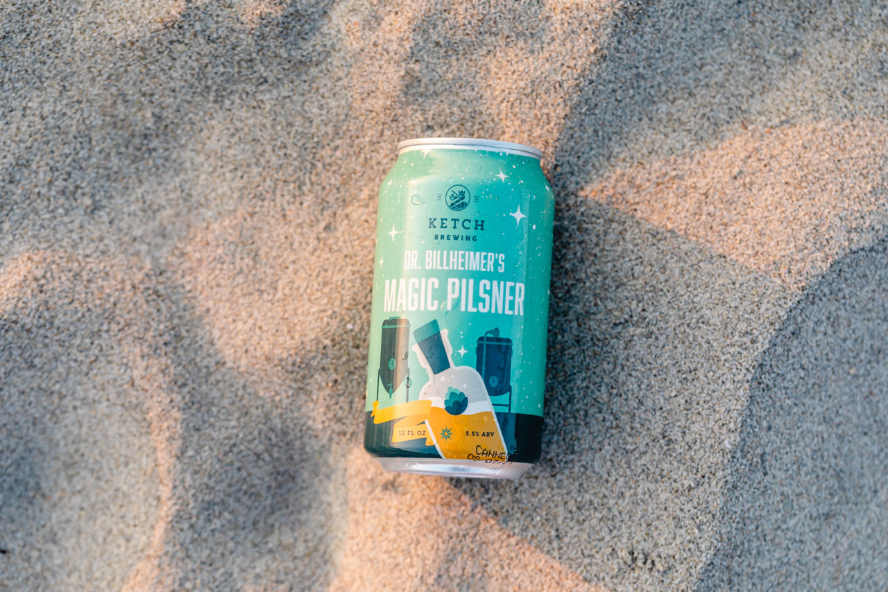 can of ketch magic pilsner lying in sand